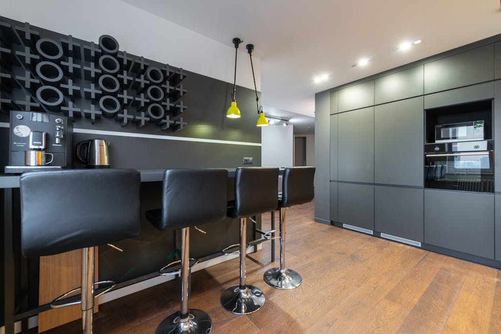 Bar Stools by a Tabletop with a Coffee Machine